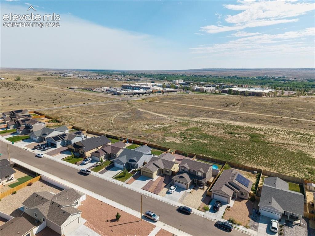 Image 31 of 36: Aerial perspective showcasing residential properties with a mix of single-s