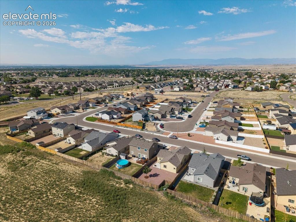 Image 32 of 36: Residential neighborhood featuring paved streets and varied home designs