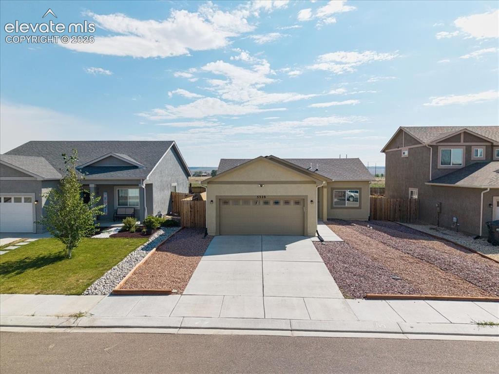 Image 34 of 36: Single-story residence featuring an attached garage, concrete driveway, and
