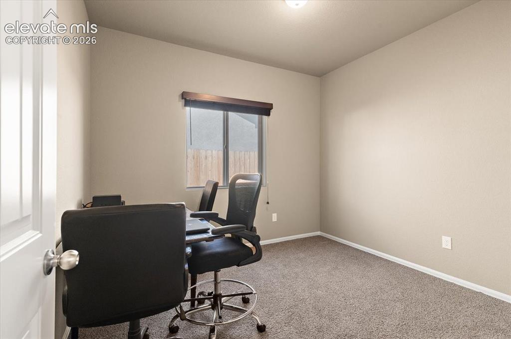 Image 9 of 36: Neutral wall tones, carpeted flooring, a recessed window, and white trim