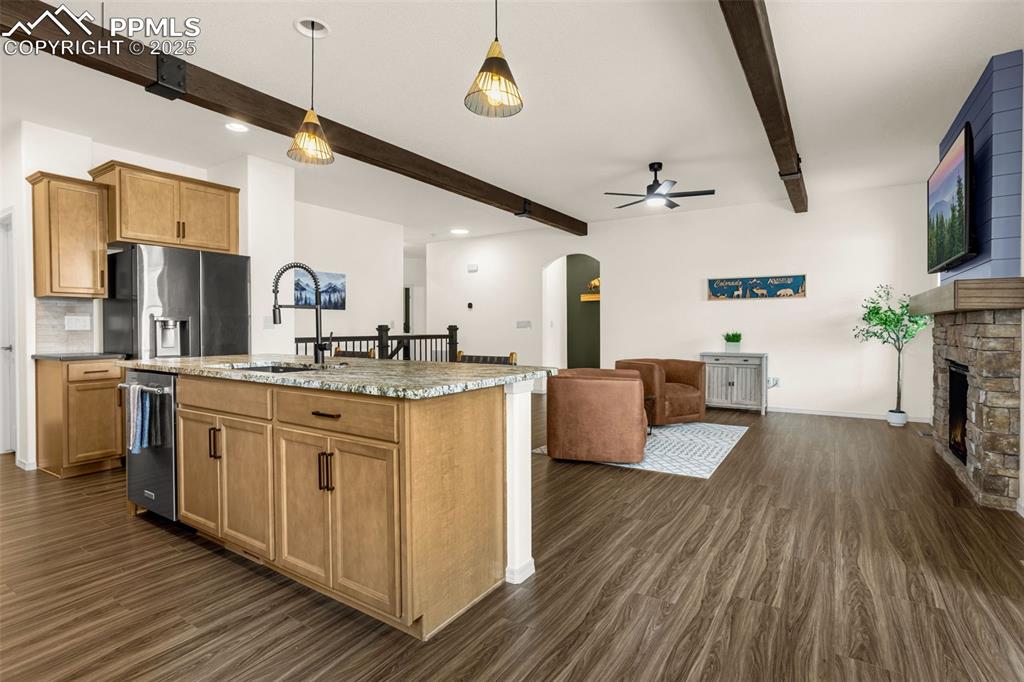 Image 11 of 41: Kitchen featuring beamed ceiling, appliances with stainless steel finishes,