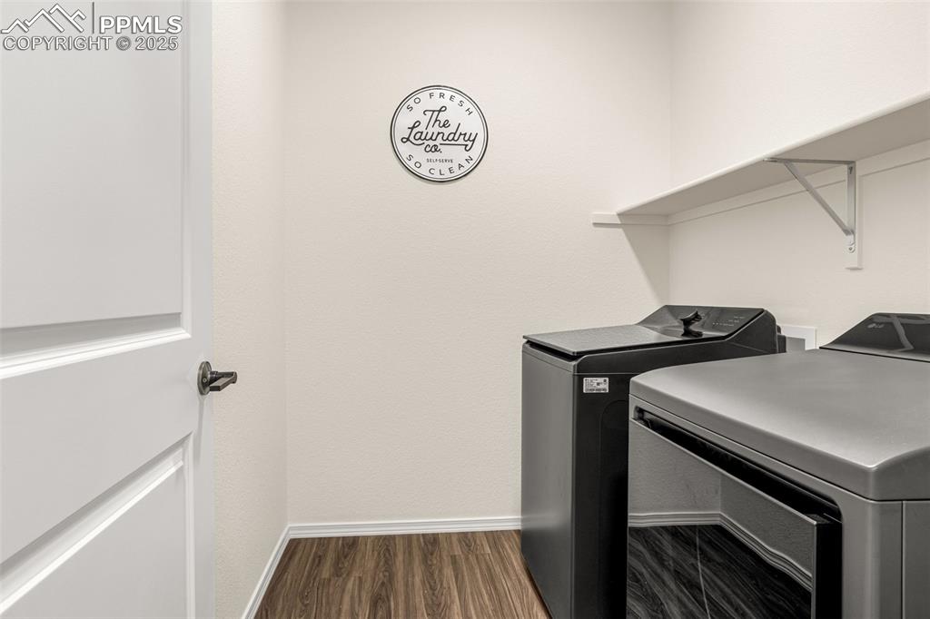 Image 14 of 41: Laundry room featuring independent washer and dryer and dark wood-style flo