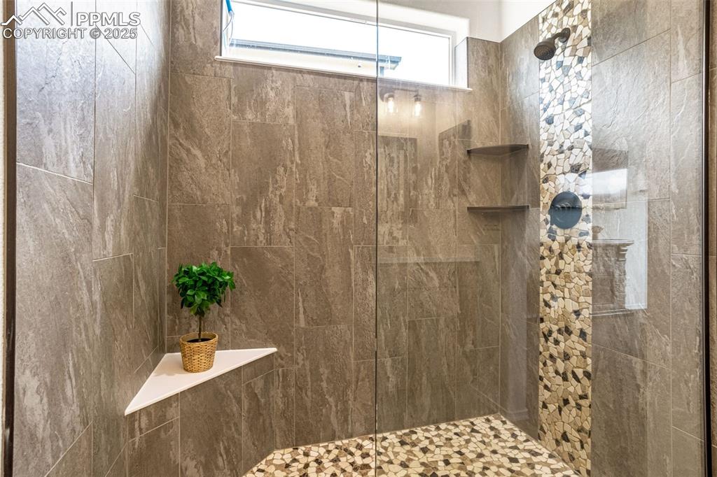 Image 20 of 41: Full bath with a tile shower