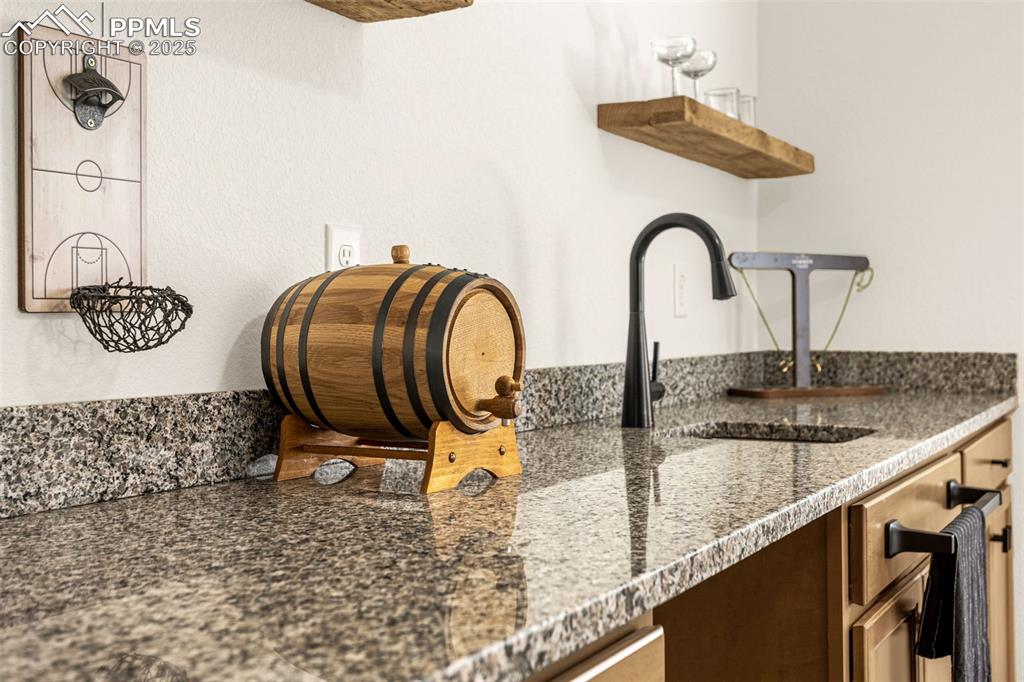 Image 27 of 41: Detailed view of a sink and dark brown cabinetry