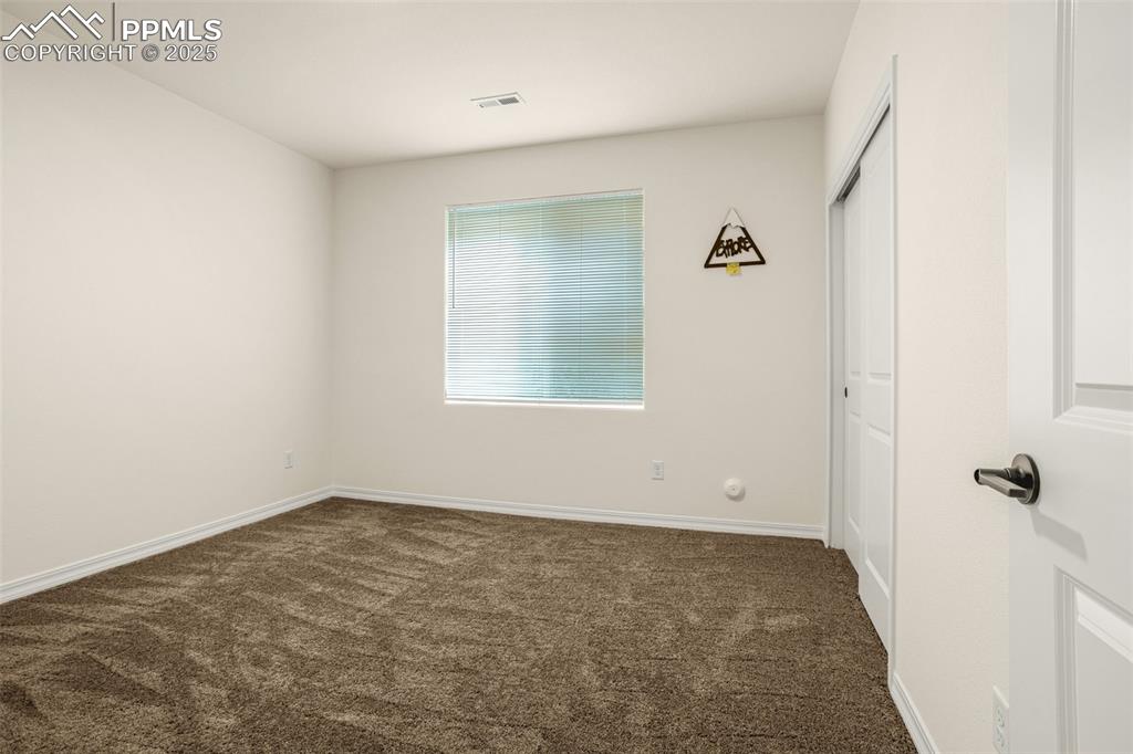 Image 29 of 41: Unfurnished room with carpet and baseboards