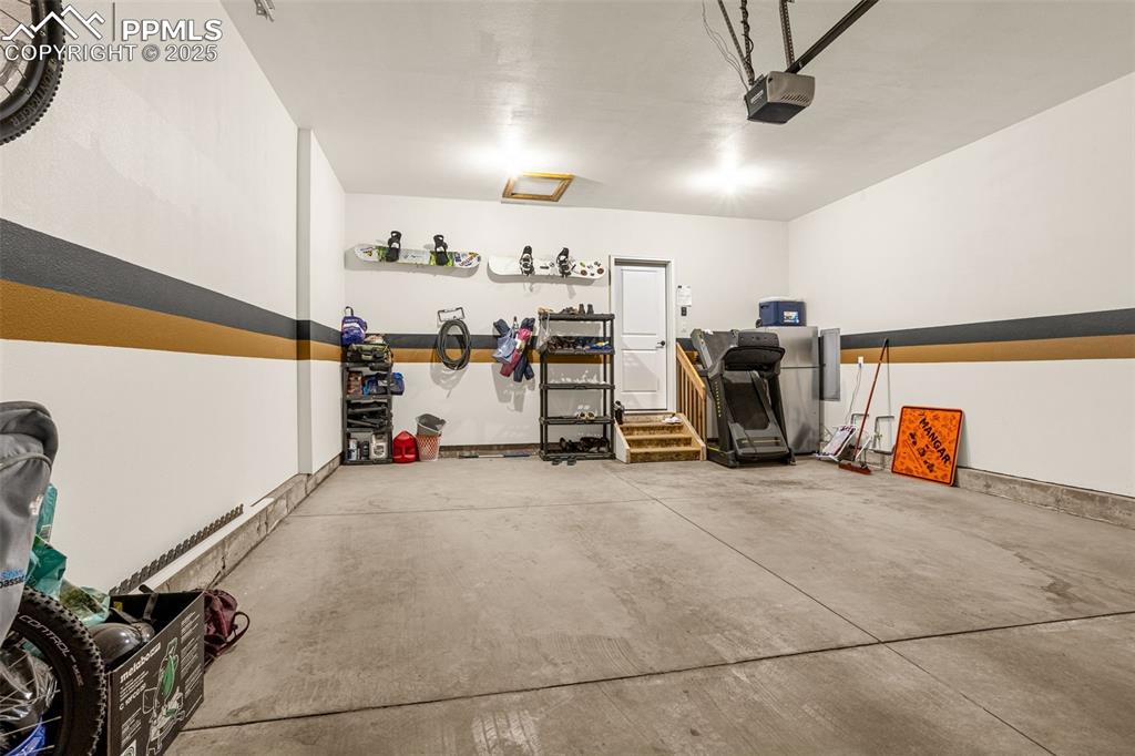 Image 30 of 41: Garage with a garage door opener