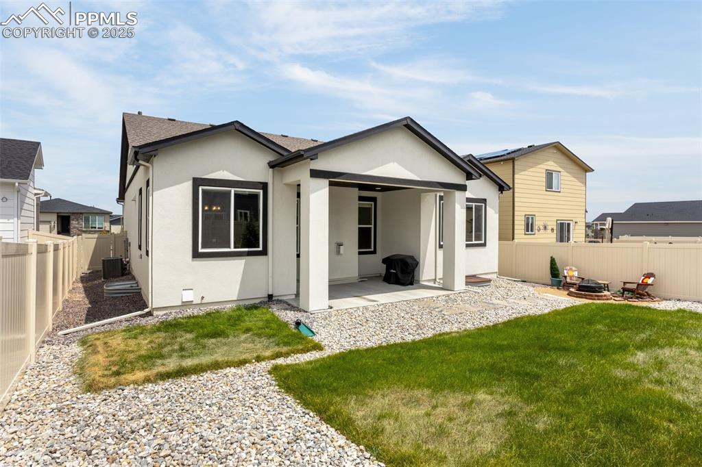 Image 32 of 41: Back of property with stucco siding, a patio area, a fenced backyard, and a