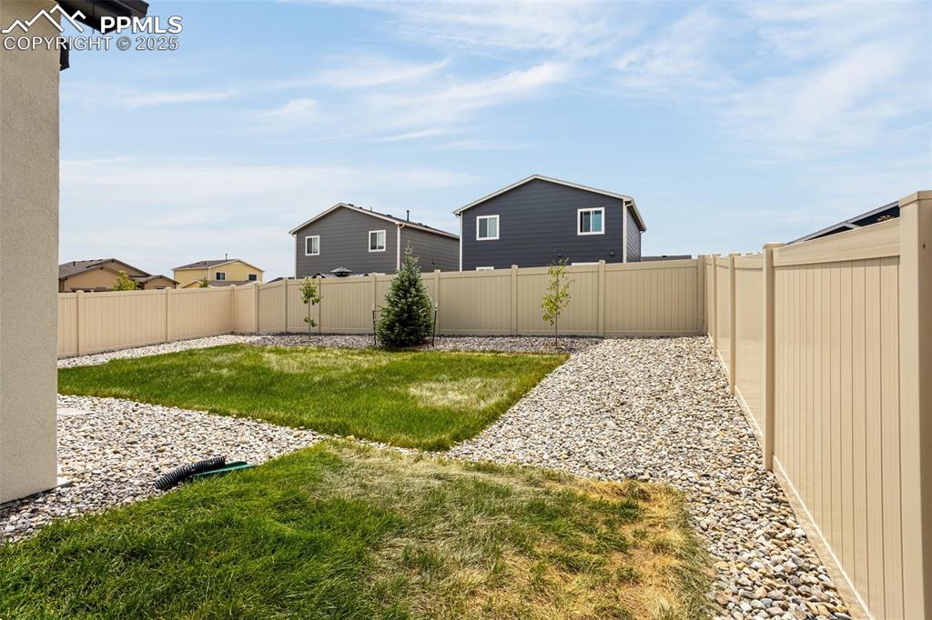 Image 33 of 41: View of fenced backyard