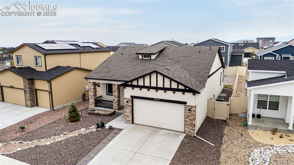 Image 36 of 41: View of front of property featuring roof with shingles, stone siding, and a