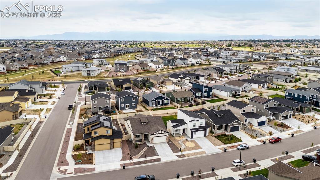 Image 40 of 41: Aerial view of residential area featuring a mountain backdrop