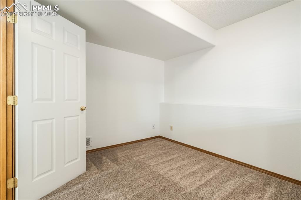 Image 22 of 34: Spare room with carpet floors and a textured ceiling