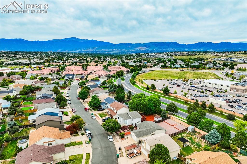 Image 33 of 34: Aerial perspective of suburban area featuring a mountain backdrop