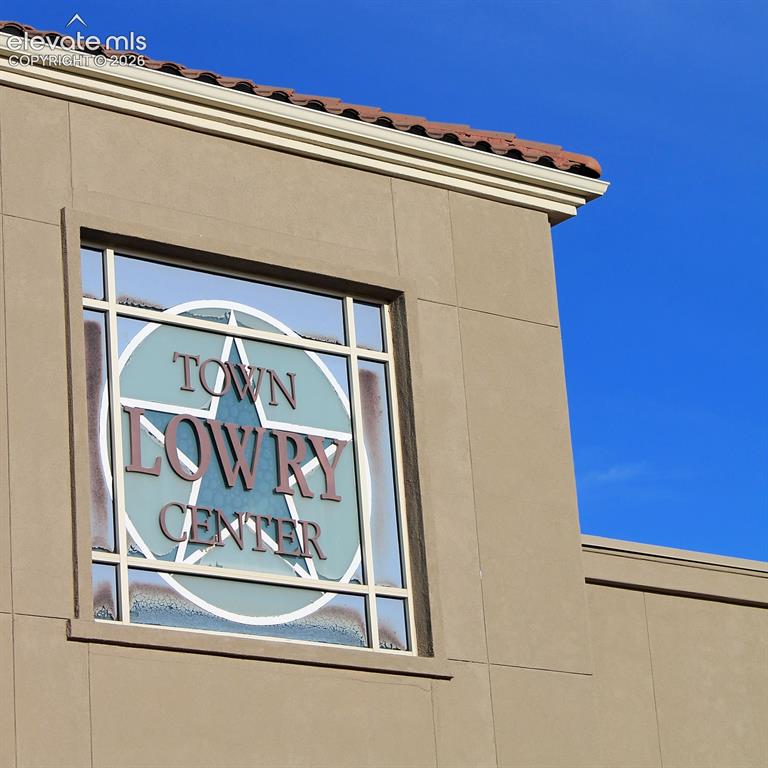 Caption: Stucco exterior featuring decorative window paneling and tile roof detailing