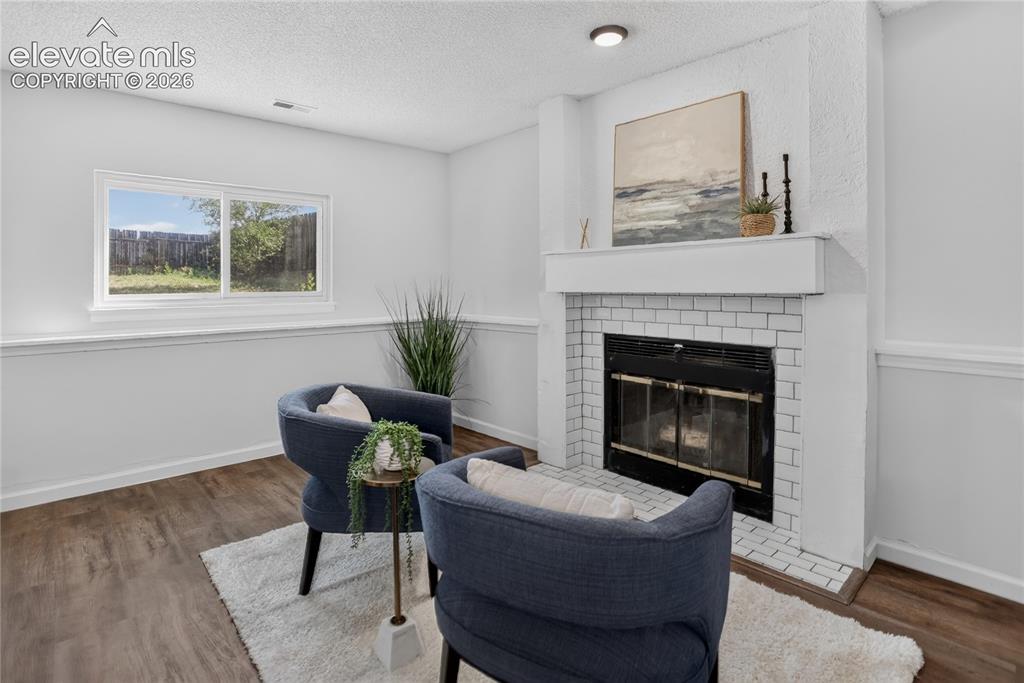 Image 14 of 20: Lower level family room w/ woodburning fireplace