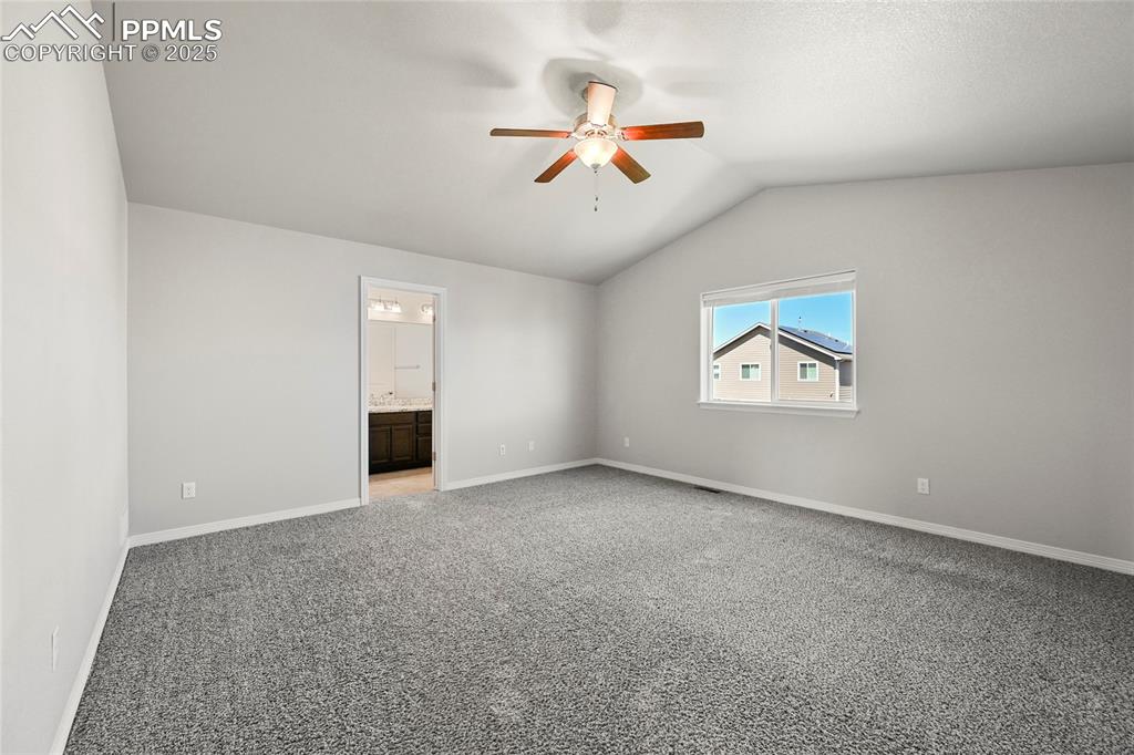 Image 15 of 29: Unfurnished room with a ceiling fan, light colored carpet, and lofted ceili