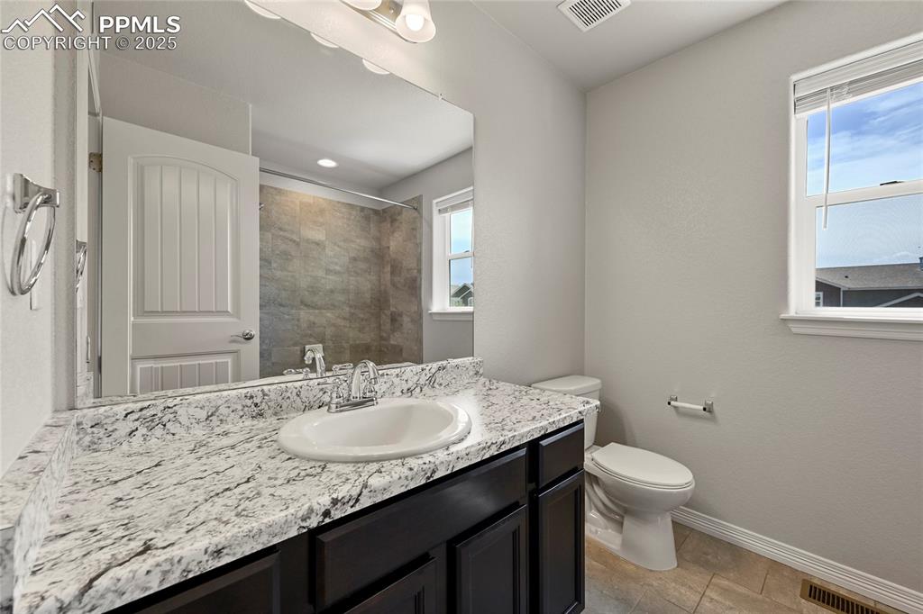 Image 22 of 29: Bathroom featuring vanity and a tile shower