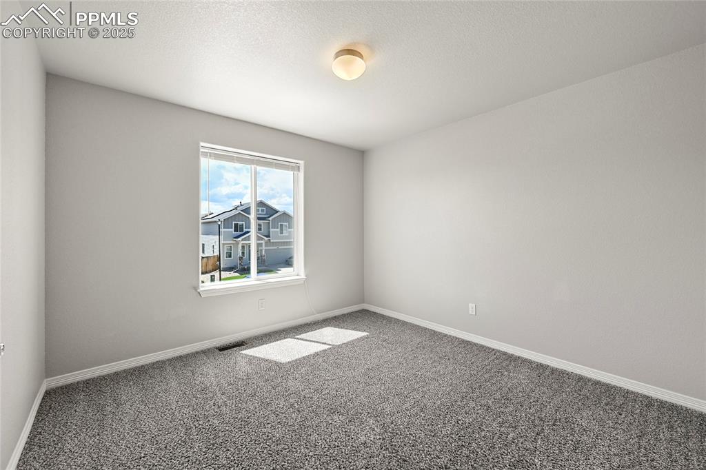 Image 25 of 29: Unfurnished room featuring carpet flooring and baseboards