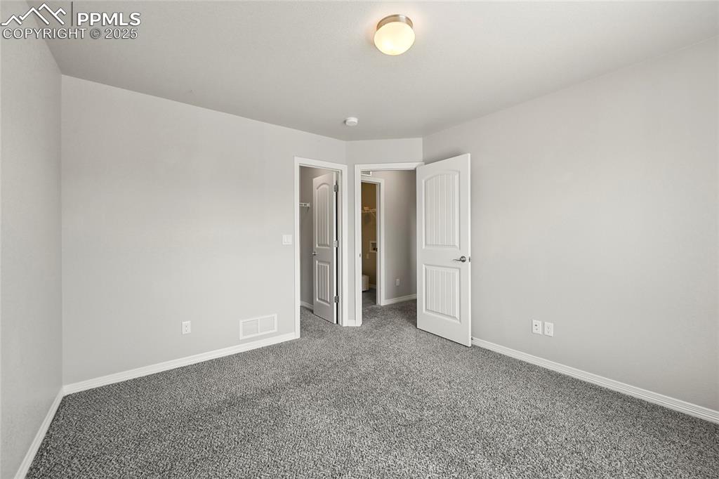 Image 26 of 29: Unfurnished bedroom with carpet and baseboards