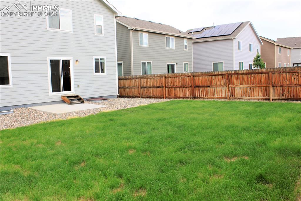 Image 29 of 29: Back of house featuring a fenced backyard and a patio