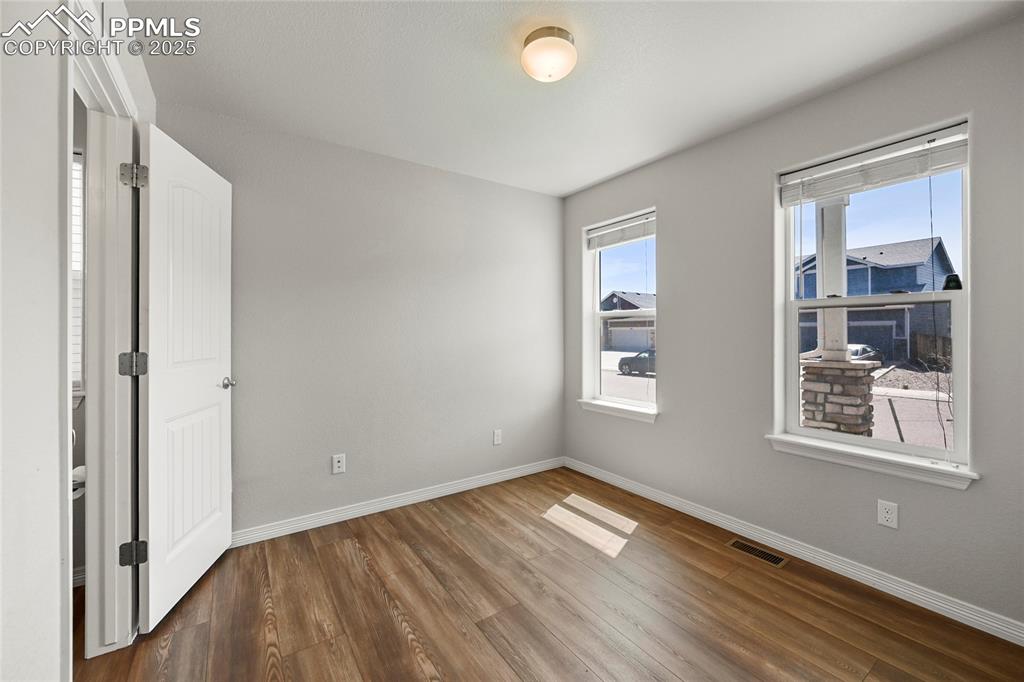 Image 3 of 29: Spare room featuring wood finished floors and plenty of natural light