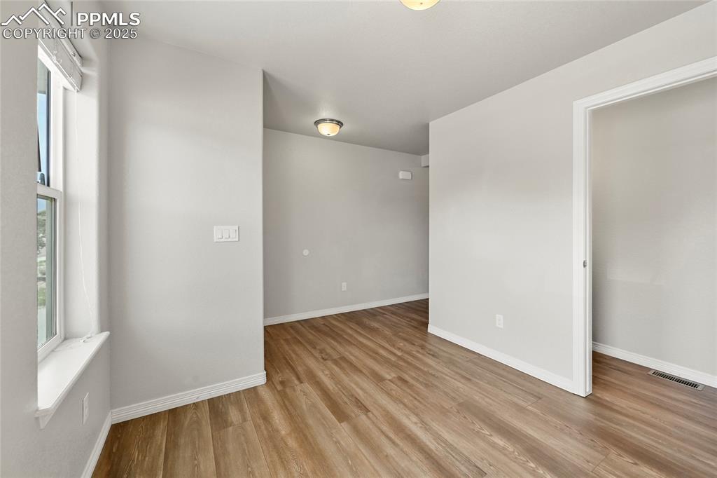 Image 4 of 29: Spare room featuring light wood-style flooring and baseboards
