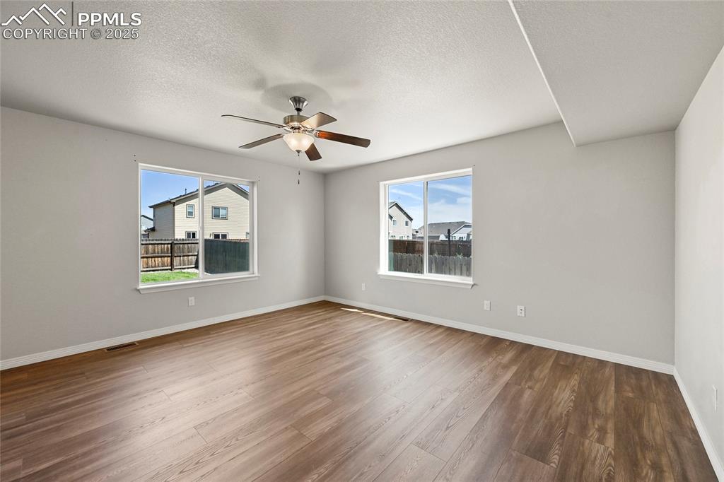 Image 7 of 29: Unfurnished room featuring plenty of natural light, wood finished floors, a