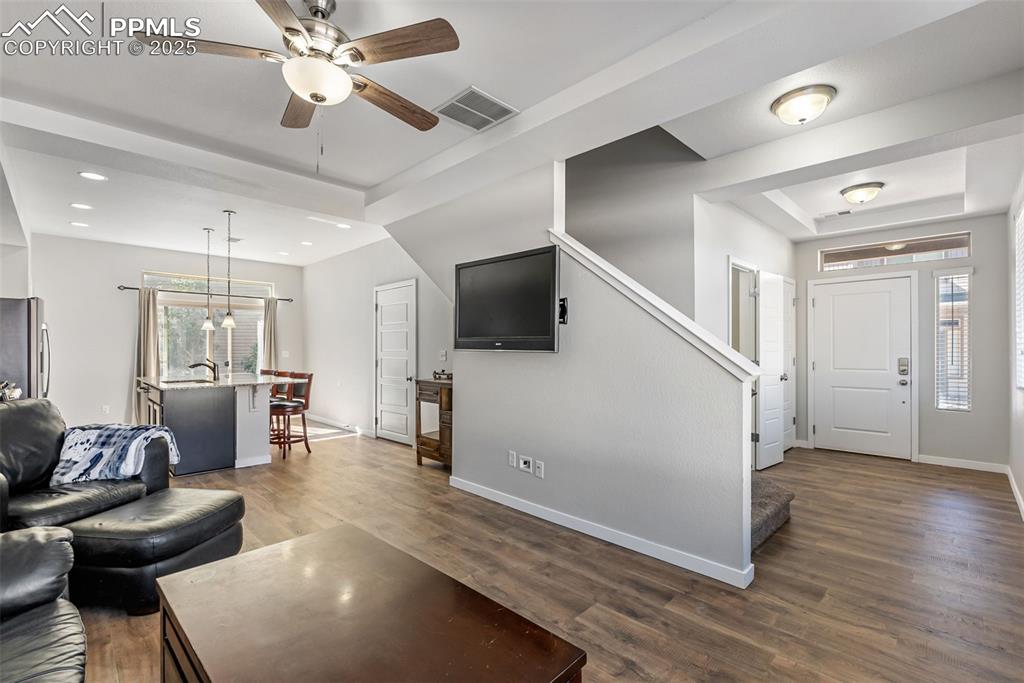 Image 12 of 50: Living area with plenty of natural light, dark wood-style flooring, ceiling