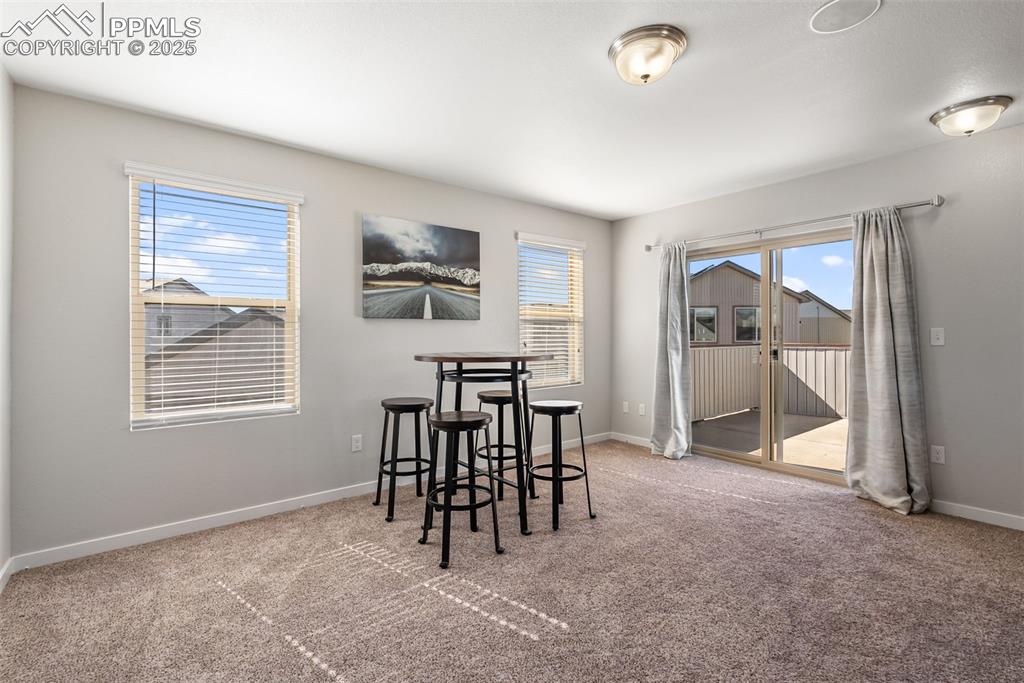 Image 30 of 50: Dining area featuring healthy amount of natural light and light colored car