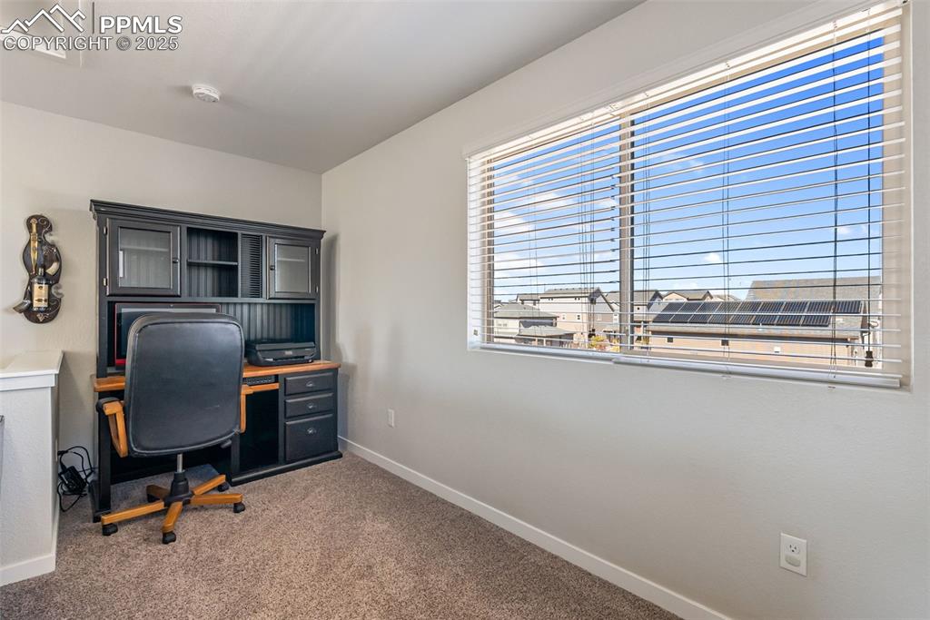 Image 34 of 50: Office area featuring carpet flooring and baseboards