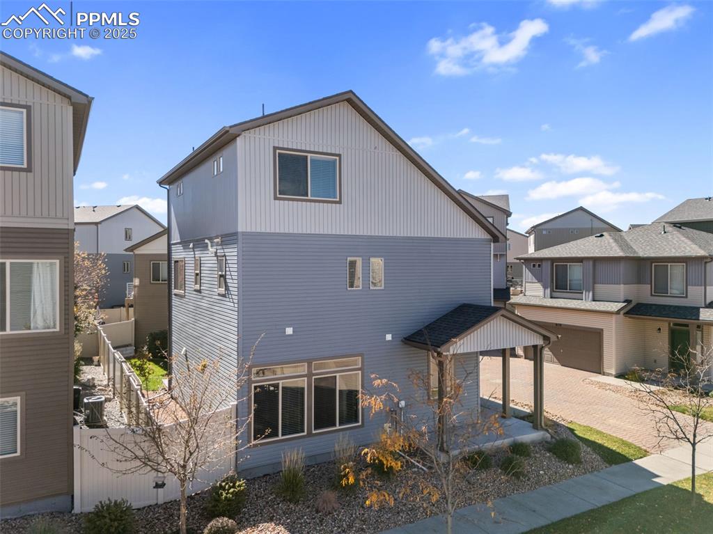 Image 41 of 50: Back of property featuring a residential view and decorative driveway