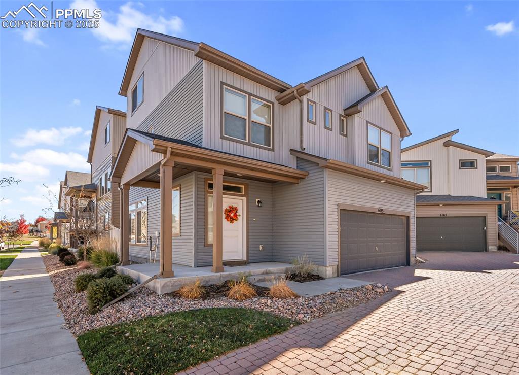 Image 42 of 50: Modern farmhouse style home with covered porch, an attached garage, decorat