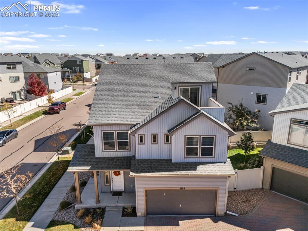Image 44 of 50: Modern inspired farmhouse featuring a shingled roof, a residential view, a