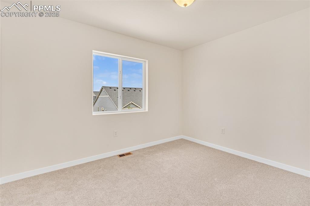 Image 15 of 39: Carpeted spare room featuring baseboards