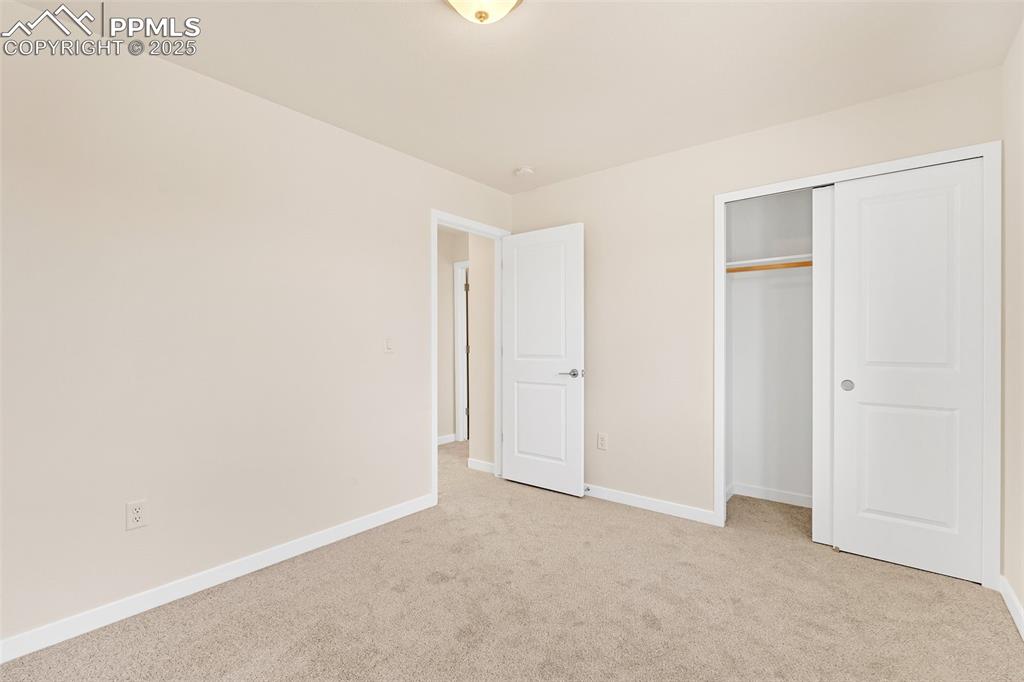 Image 16 of 39: Unfurnished bedroom with light carpet and a closet
