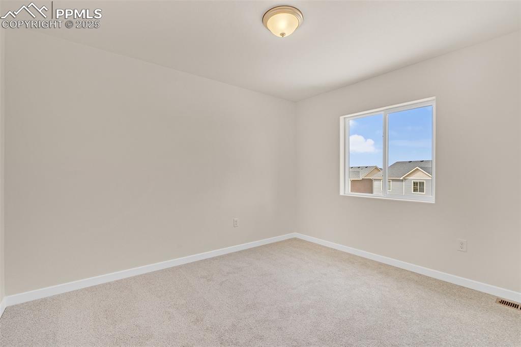 Image 17 of 39: Spare room with light carpet and baseboards