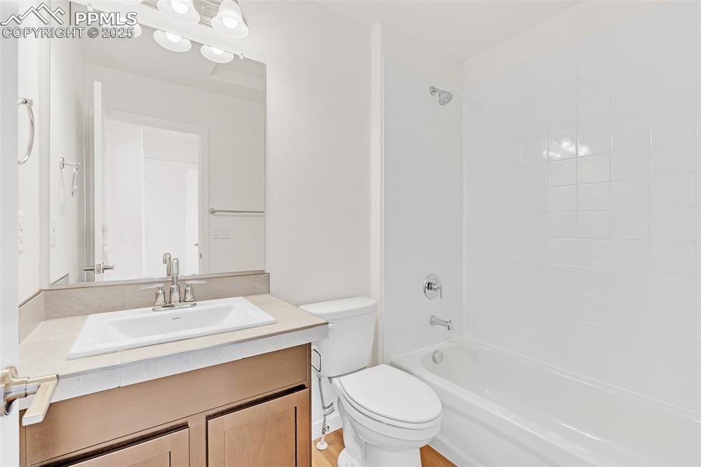 Image 19 of 39: Full bathroom with shower / bathtub combination and vanity