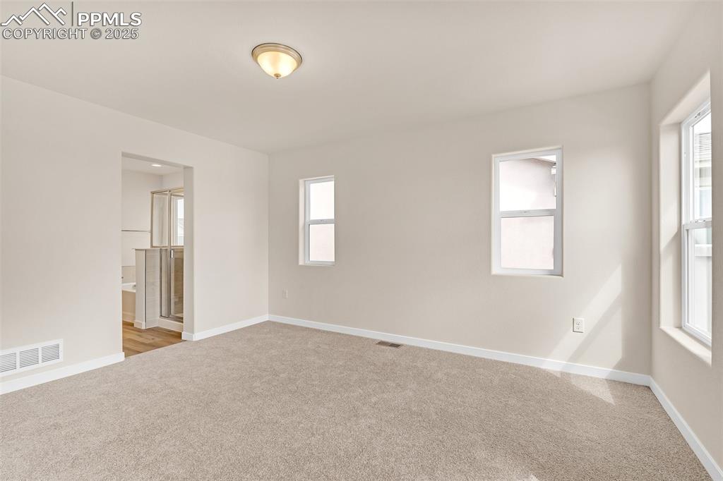 Image 24 of 39: Spare room featuring light colored carpet