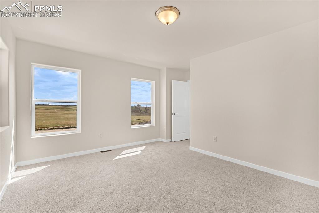 Image 25 of 39: Carpeted empty room featuring baseboards