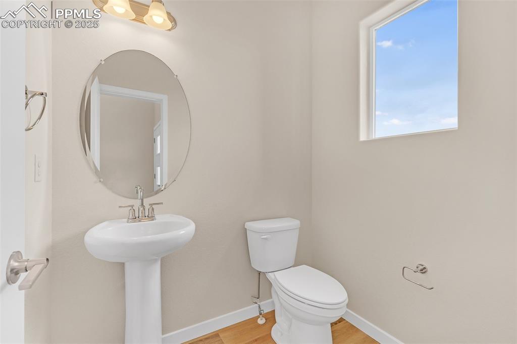 Image 8 of 39: Bathroom with baseboards and light wood-style flooring