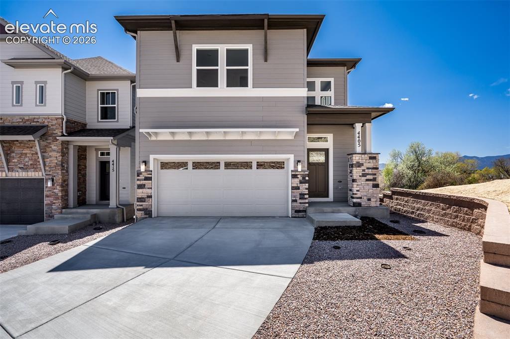 Image 2 of 45: Contemporary multi-level exterior featuring gray siding with white trim acc