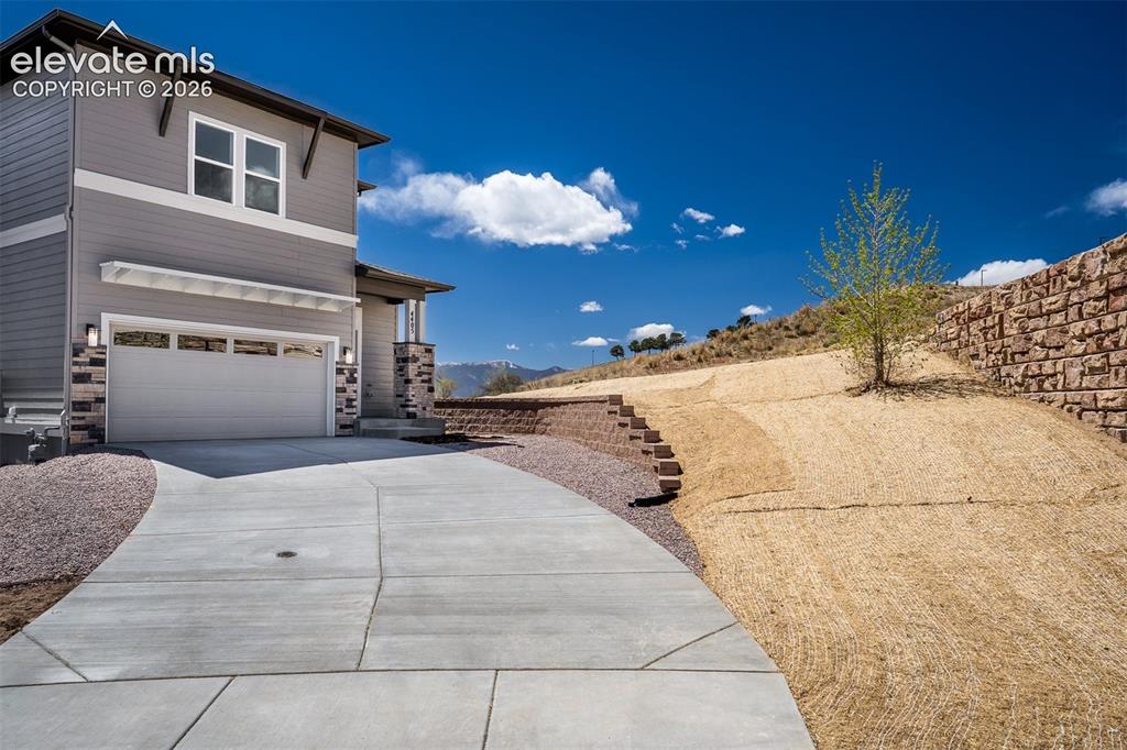 Image 3 of 45: Contemporary multi-level exterior featuring gray siding with white trim acc