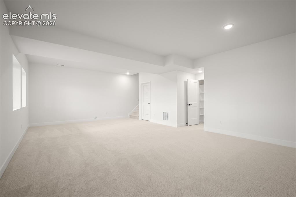 Image 36 of 45: Spacious finished basement with light-colored carpeting, neutral wall tones