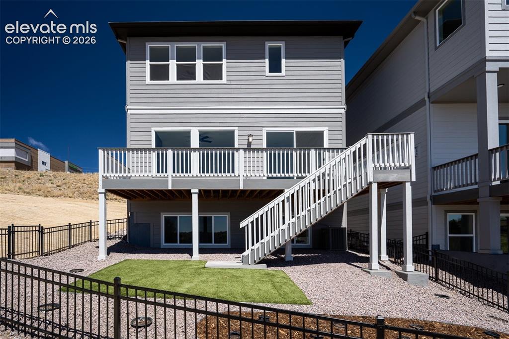 Image 40 of 45: Rear exterior featuring a two-story design with gray siding with white trim