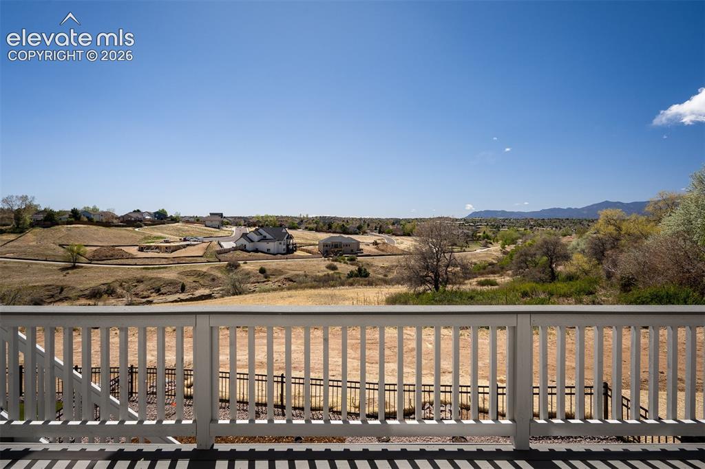 Image 43 of 45: Spacious outdoor deck featuring composite decking with a white railing over