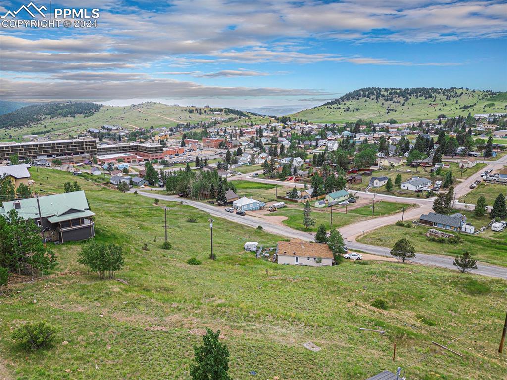 Caption: Aerial view of property overlooking city of Cripple Creek, backdropped with beautiful Colorado mount