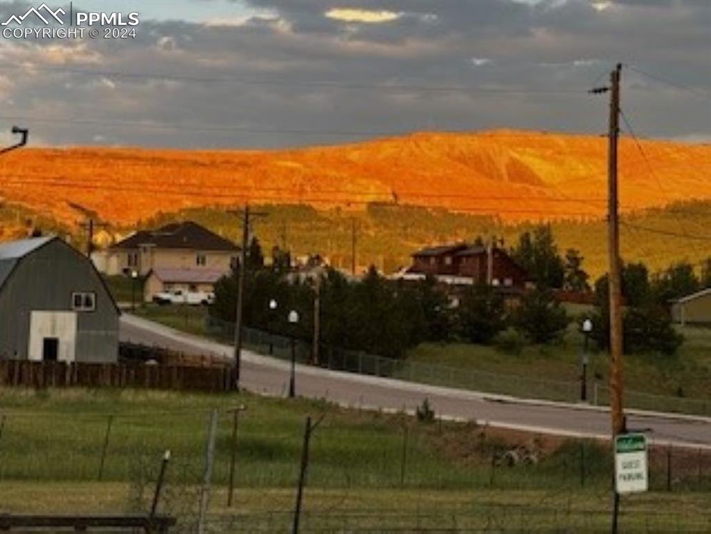 Image 18 of 19: Sunset of gold flowing on the mining hill in Cripple Creek. 