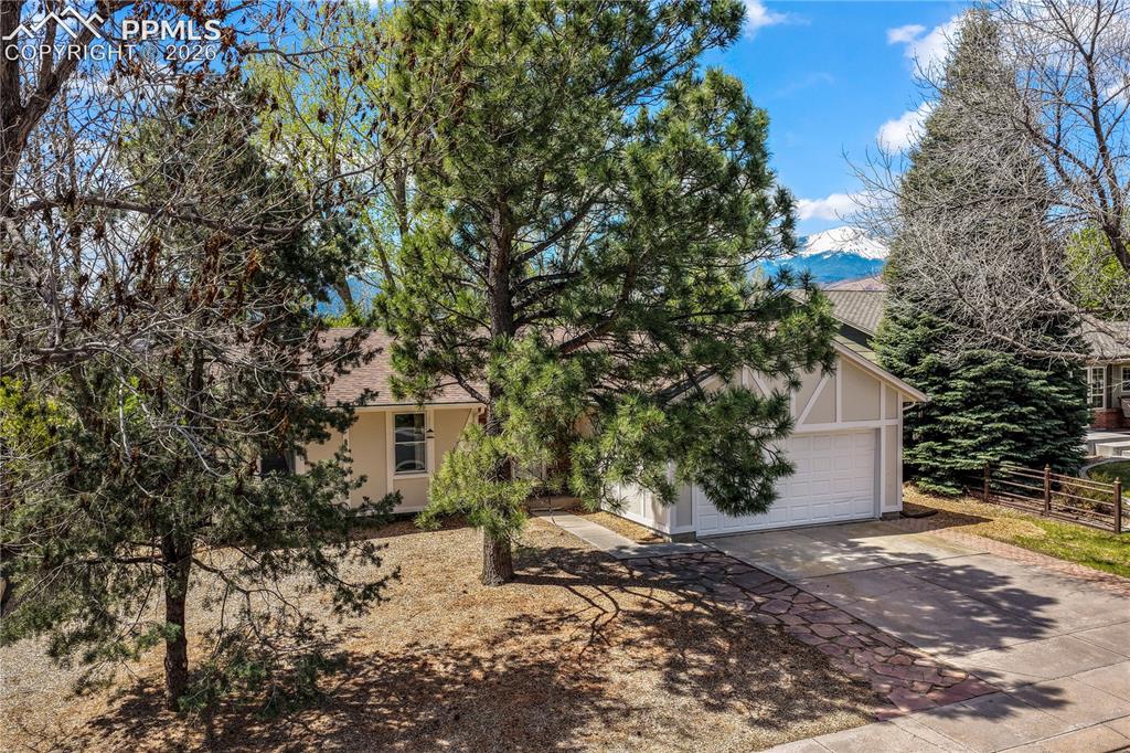 Image 8 of 50: Front of home, mature trees