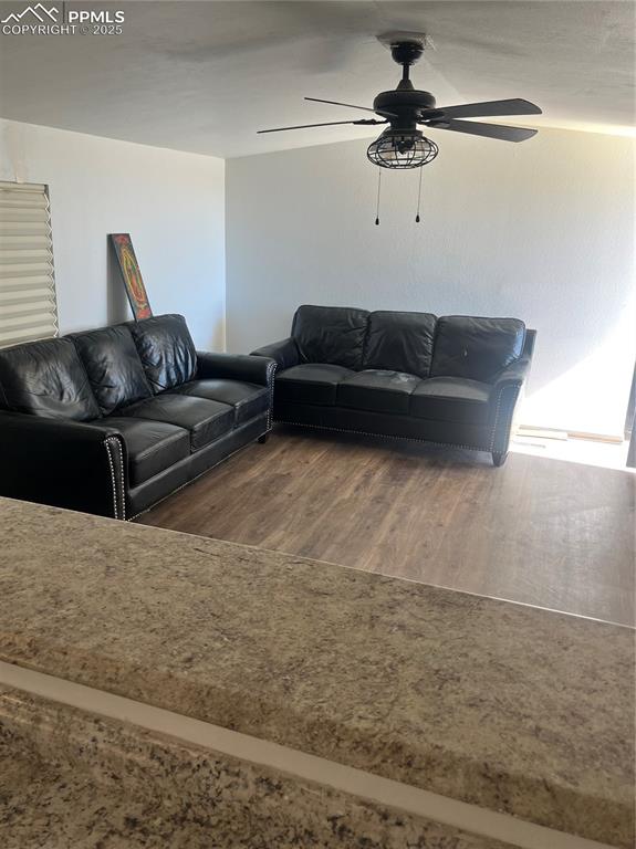 Image 5 of 11: Living room featuring wood finished floors