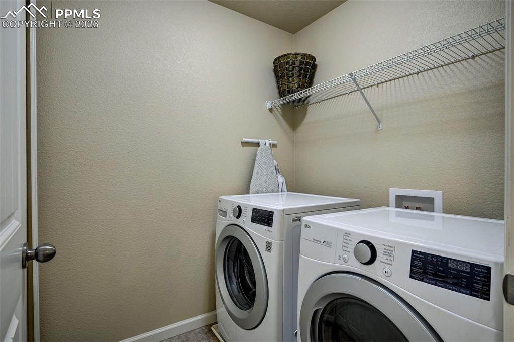 Image 25 of 34: Upstairs laundry room with all the bedrooms.