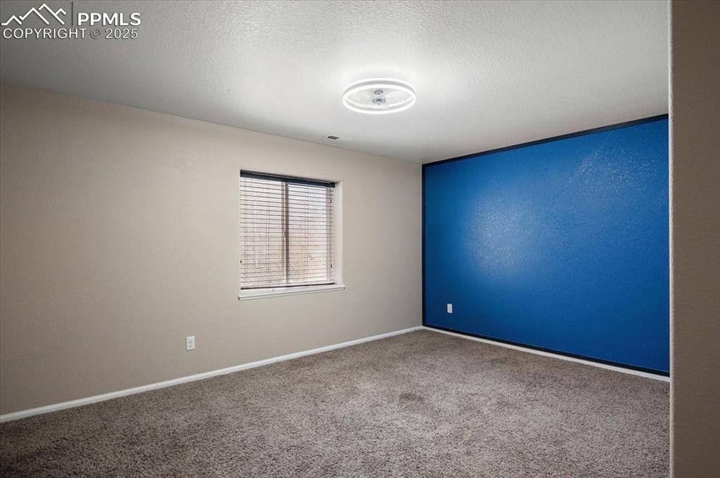 Image 13 of 35: Empty room featuring carpet and a textured ceiling